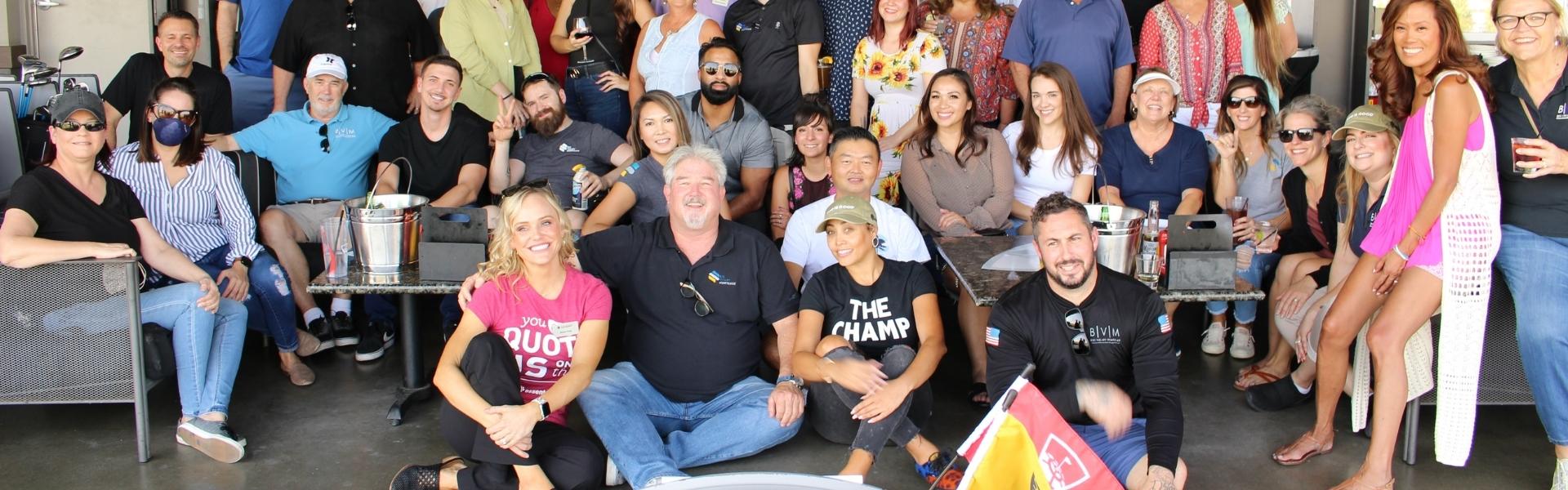 About Us page header image. A photo of some of the Big Valley Mortgage staff posing together on a company trip to Top Golf.